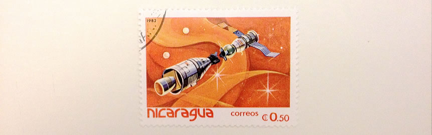 A photo of stamp with a picture of a satellite on it