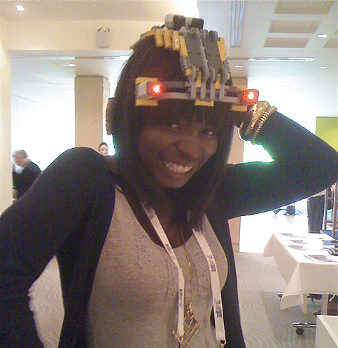 Photo of Oyin wearing a hat made of lego